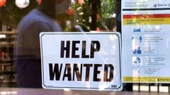 A &#039;Help Wanted&#039; sign is poster at a restaurant in Los Angeles, California. - Fewer Americans filed unemployment benefit claims last week, government data said.