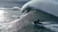 Un surfista en una de las olas gigantes del swell XL que rompi&oacute; en Praia do Norte, Nazar&eacute; (Portugal) el 7 de noviembre del 2022, con un jet ski de Red Bull sigui&eacute;ndole para el posterior rescate. 