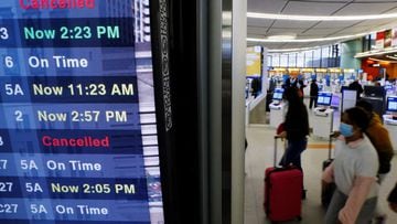 A board displays the status of flights to and from Logan International Airport in Boston.