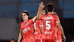 Argentinos Juniors' midfielder Francisco Gonzalez (L) celebrates with teammate Federico Redondo after scoring his team's first goal during the Copa Libertadores group stage first leg football match between Uruguay's Liverpool and Argentina's Argentinos Juniors, at the Centenario stadium in Montevideo, on May 2, 2023. (Photo by DANTE FERNANDEZ / AFP)