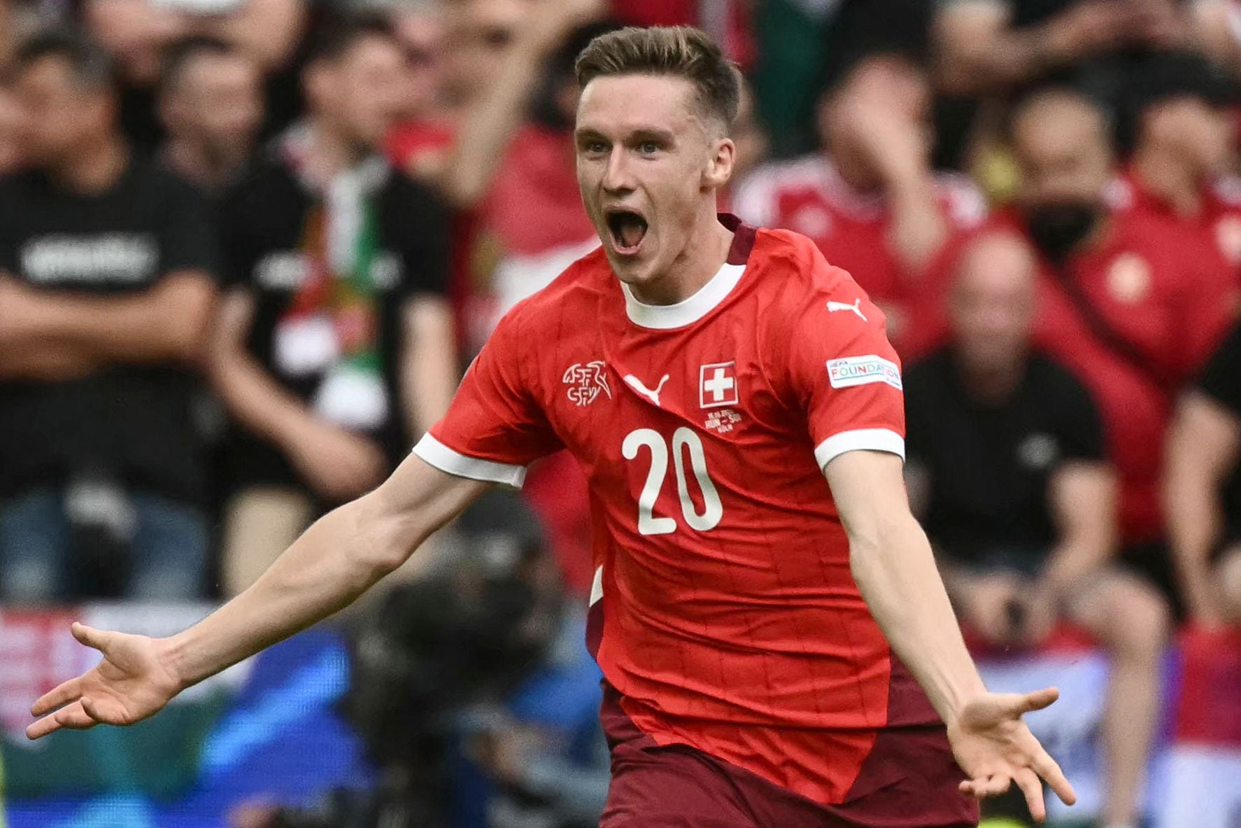 Switzerland's midfielder #20 Michel Aebischer celebrates scoring his team's second goal during the UEFA Euro 2024 Group A football match between Hungary and Switzerland at the Cologne Stadium in Cologne on June 15, 2024. (Photo by Angelos Tzortzinis / AFP)
