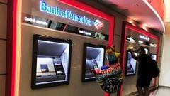 FILE PHOTO: A man uses an ATM machine next an inflatable plastic balloon inside a Bank of America branch in Times Square in New York, U.S., August 10, 2019. REUTERS/Nacho Doce/File Photo