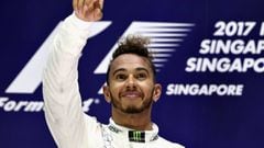 SINGAPORE - SEPTEMBER 17:  Race winner Lewis Hamilton of Great Britain and Mercedes GP celebrates on the podium during the Formula One Grand Prix of Singapore at Marina Bay Street Circuit on September 17, 2017 in Singapore.  (Photo by Mark Thompson/Getty 
