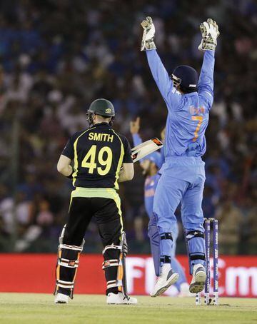 India's MS Dhoni appeals successfully for a catch to dismiss Australia's Steven Smith.