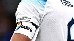 (FILES) In this file photo taken on September 24, 2022, England's forward Harry Kane wearing a rainbow armband. reacts after losing the UEFA Nations League's League A Group 3 match between Italy and England, at the San Siro Stadium in Milan. - England, Germany and five other European teams at the World Cup on Monday, November 21, abandoned plans to wear a rainbow-themed armband in support of LGBTQ rights, citing the threat of disciplinary action from FIFA. The "OneLove" armband due to be warn by the likes of England captain Harry Kane and Germany counterpart Manuel Neuer is designed as part of a campaign to promote inclusivity. (Photo by Marco BERTORELLO / AFP)