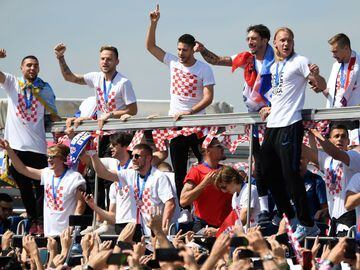 Croatian national football team members ride an open-roof coach in Zagreb International Airport on July 16, 2018 after their return from the FIFA World Cup 2018 in Russia in Zagreb International Airport on July 16, 2018.   / AFP PHOTO / ATTILA KISBENEDEK