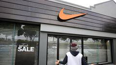 A man gives a photo-friendly reaction as he finds a Nike store closed in Cape Town, South Africa, August 22, 2018. 