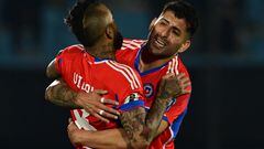 Chile's midfielder Arturo Vidal (L) celebrates with teammate defender Guillermo Maripan after scoring a goal during the 2026 FIFA World Cup South American