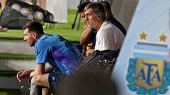 Argentina's forward Lionel Messi (L) looks on from the bench during a training camp in Abu Dhabi ahead of the Qatar 2022 FIFA football World Cup, at the Nahyan Stadium, on November 14, 2022. (Photo by Karim SAHIB / AFP)