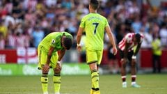 Manchester United's Bruno Fernandes, (left) is dejected at the final whistle as team mate Cristiano Ronaldo walks off during the Premier League match at the Gtech Community Stadium, Brentford. Picture date: Saturday August 13, 2022.