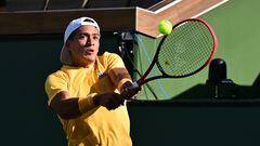 Sebastian Baez of Argentina hits a backhand return to Taylor Fritz of the US in their third round match at the 2023 WTA Indian Wells Open in Indian Wells, California, on March 13, 2023. (Photo by Frederic J. BROWN / AFP)