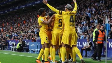 Barcelona's players celebrate their opening goal scored by Polish forward Robert Lewandowski during the Spanish league football match between RCD Espanyol and FC Barcelona at�the RCDE Stadium in Cornella de Llobregat on May 14, 2023. (Photo by Lluis GENE / AFP)