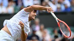 Chile&#039;s Cristian Garin serves against Serbia&#039;s Novak Djokovic during their men&#039;s singles fourth round match on the seventh day of the 2021 Wimbledon Championships at The All England Tennis Club in Wimbledon, southwest London, on July 5, 2021. (Photo by Glyn KIRK / AFP) / RESTRICTED TO EDITORIAL USE