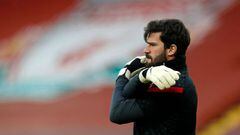 Liverpool&#039;s Brazilian goalkeeper Alisson Becker warms up ahead of the English Premier League football match between Liverpool and Everton at Anfield in Liverpool, north west England on February 20, 2021. (Photo by PHIL NOBLE / POOL / AFP) / RESTRICTE