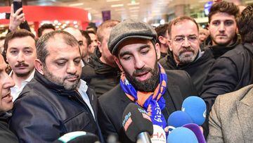 Barcelona&#039;s Turkish midfielder Arda Turan speaks to the media as he arrives at Ataturk International Airport in Istanbul on January 13, 2018. 