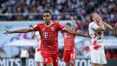 30 July 2022, Saxony, Leipzig: Soccer: DFL Supercup, RB Leipzig - Bayern Munich, Red Bull Arena. Bayern's Jamal Musiala celebrates his goal to make it 1:0, Leipzig's Lukas Klostermann reacts on the right. Photo: Hendrik Schmidt/dpa - IMPORTANT NOTE: In accordance with the requirements of the DFL Deutsche Fußball Liga and the DFB Deutscher Fußball-Bund, it is prohibited to use or have used photographs taken in the stadium and/or of the match in the form of sequence pictures and/or video-like photo series. (Photo by Hendrik Schmidt/picture alliance via Getty Images)