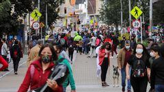 FILE PHOTO: FILE PHOTO: People wearing face masks walk down a street before the start of a mandatory total isolation decreed by the mayor's office, amidst an outbreak of the coronavirus disease (COVID-19), in Bogota, Colombia January 7, 2021. REUTERS/Luisa Gonzalez/File Photo/File Photo