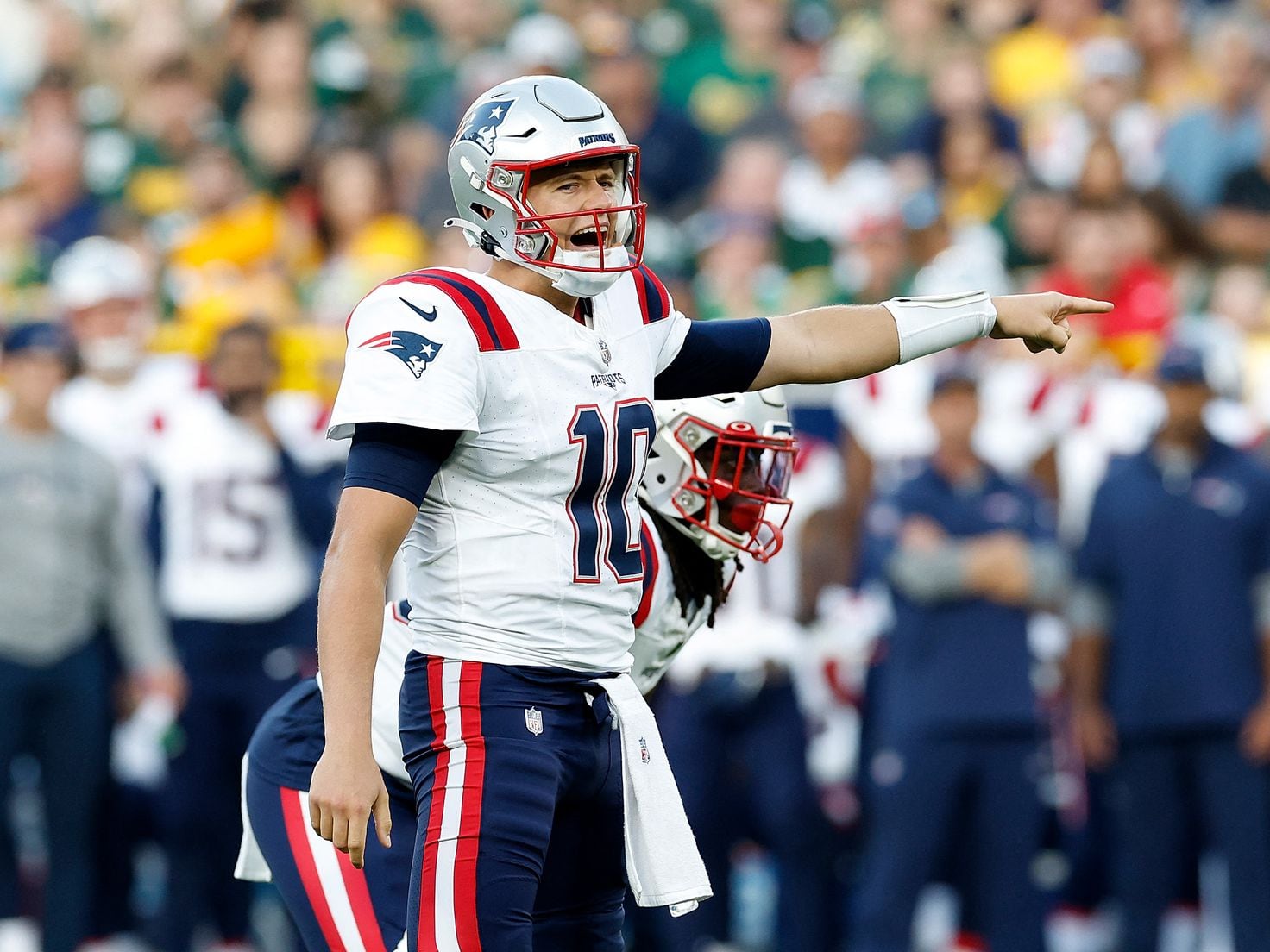 AFC quarterback Mac Jones of the New England Patriots (10) looks for a  receiver versus the NFC …