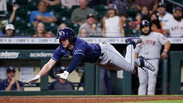 Brett Phillips of the Tampa Bay Rays dives attempting to stretch a triple into an inside-the-park home run but was tagged out on the play in the eighth inning against the Houston Astros. 