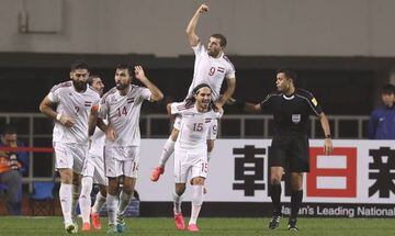 Syria's Mahmoud Al Mawas and team mates celebrate after scoring Syria's goal against China.