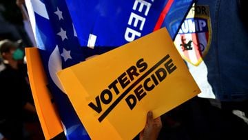 FILE PHOTO: A &quot;Voters Decide&quot; sign is pictured as people demonstrate outside of the Philadelphia Convention Center, where votes are still being counted two days after the 2020 U.S. presidential election, in Philadelphia, Pennsylvania, U.S. Novem