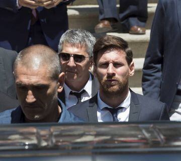 Messi leaves court with his father (second left) on Wednesday.