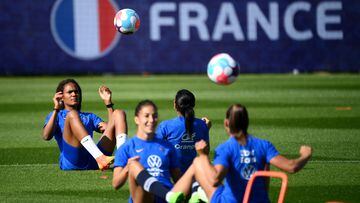 France's defender Wendie Renard (L) plays the ball during a training session at the team's base camp in Ashby-de-la-Zouch in central England, on July 5, 2022, during the UEFA Euro 2022 football tournament. (Photo by FRANCK FIFE / AFP)