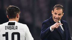 Juventus' Italian coach Massimiliano Allegri (R) speaks with Juventus' Argentine forward Paulo Dybala during the Italian Serie A football match between Napoli and Juventus on March 3, 2019, at the San Paolo Stadium in Naples.