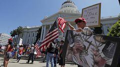 People protest during a reopen California demonstration at the State Capital in Sacramento, California. 
