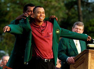 FILE PHOTO: ON THIS DAY -- April 8 April 8, 2001 GOLF - American Tiger Woods receives the traditional green jacket from former champion Vijay Singh of Fiji after winning the Masters at the Augusta National Golf Club.