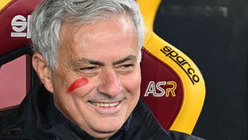 Roma's Portuguese head coach Jose Mourinho, with a red mark on his cheek to mark the International Day for the Elimination of Violence against Women, smiles from the bench prior to the Italian Serie A football match between AS Roma and Udinese on November 26, 2023 at the Olympic stadium in Rome. (Photo by Alberto PIZZOLI / AFP)