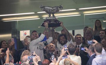 Sergio Ramos (left) and Marcelo lift the Bernabéu Trophy.