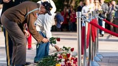 Darrell Bush, 96, left, a former US Army Staff Sgt., from Camp Springs, Maryland, and a WWII veteran of the Battle of the Bulge, places a flower with his wife Dorothy Bush, during a centennial commemoration event at the Tomb of the Unknown Soldier, in Arl