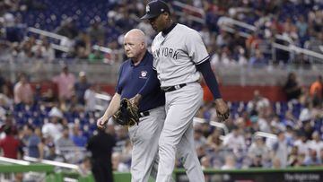 New York Yankees relief pitcher Aroldis Chapman, right, leaves the game with an injury during the twelfth inning of a baseball game against the Miami Marlins, Tuesday, Aug. 21, 2018, in Miami. The Yankees won 2-1 in twelve innings. (AP Photo/Lynne Sladky)