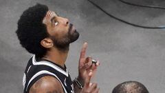 Brooklyn Nets guard Kyrie Irving, left, gestures upward near the end of Game 4 against the Boston Celtics during an NBA basketball first-round playoff series, Sunday, May 30, 2021, in Boston. (AP Photo/Elise Amendola)