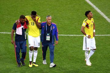 Mina (second left) and Johan Mojica (right) walk off dejected after Colombia's penalty shoot-out defeat to England.