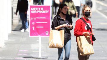 Pedestrians carry shopping bags as they walk through the Union Square shopping district in San Francisco, California.