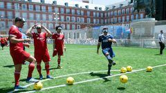 Portuguese former football player Luis Figo (R) shoots a penalty kick blindfolded during the UEFA&#039;s #EqualGame campaign at the Plaza Mayor square in Madrid on May 31, 2019 on the eve of the UEFA Champions League final football match between Liverpool