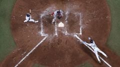 07 October 2021, US, St. Petersburg: Rays&#039; Randy Arozarena (R), slides into home plate as Red Sox catcher Christian Vazquez (C), anticipates the throw while Rays second baseman Brandon Lowe (L), and umpire Dan Bellino watch the play during the sevent