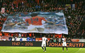 A banner with a picture of deceased legendary soccer player Johan Cruyff who played with number 14, is seen as players of the Dutch and French soccer squads observed a minute of silence in the 14th minute of the game during the international friendly socc