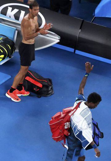 Spain's Rafael Nadal applauds as France's Gael Monfils waves