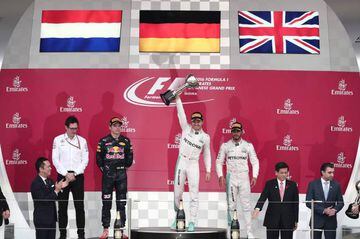Mercedes AMG Petronas Nico Rosberg holds up his winner's trophy as Red Bull Racing's Max Verstappen and teammate Lewis Hamilton look on.