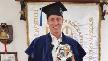 This Handout photo made available by the School of Education in Sport shows Poland&#039;s forward Robert Lewandowski posing for a photo after finishing his thesis at the college in Warsaw, Poland on October 9, 2017. The top scorer in the history of Polis