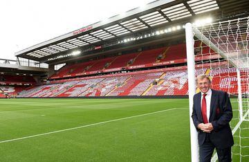 Kenny Dalglish leans against the goalpost at the Kop end of Anfield with the  newly-named Kenny Dalglish Stand behind him.