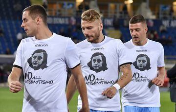 Lazio's players Ciro Immobile (C), Adam Marusic (L) and Sergej Milinkovic-Savic wear a shirt with a picture of Anne Frank before their Serie A soccer match against Bologna