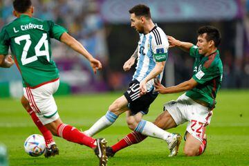 LUSAIL CITY, QATAR - NOVEMBER 26: Lionel Messi #10 of Argentina and Hirving Lozano #22 of Mexico compete for the ball during the FIFA World Cup Qatar 2022 Group C match between Argentina and Mexico at Lusail Stadium on November 26, 2022 in Lusail City, Qatar. (Photo by Fu Tian/China News Service via Getty Images)