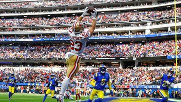 INGLEWOOD, CALIFORNIA - OCTOBER 30: Christian McCaffrey #23 of the San Francisco 49ers catches the ball for a touchdown as Jalen Ramsey #5 and Taylor Rapp #24 of the Los Angeles Rams defend during the third quarter at SoFi Stadium on October 30, 2022 in Inglewood, California. (Photo by Ronald Martinez/Getty Images)