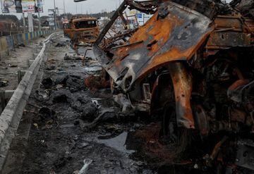 Bodies of Russian soldiers lie near burned military vehicles on the road to Kyiv.