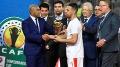 (FILES) In this file photo taken on May 26, 2019 Egypt&#039;s Zamalek player Hazem Emam (C) receives the trophy from the president of the African Football Federation Ahmed Ahmed (L) after they won the CAF Confederation Cup final football match between Egy