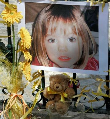 Poster of the missing three-year-old British girl Madeleine McCann is surrounded by flowers and hope-bows in the Portuguese beach resort of Lagos May 12, 2007.